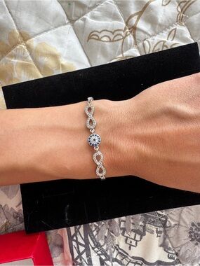 Sterling Silver Infinity Bracelet with Blue Crystal Accent